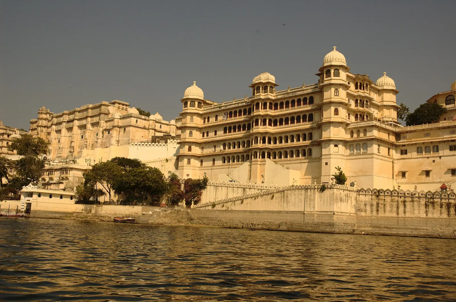 The long white facade of the City Palace above Lake Pichola in Udaipur, Rajasthan