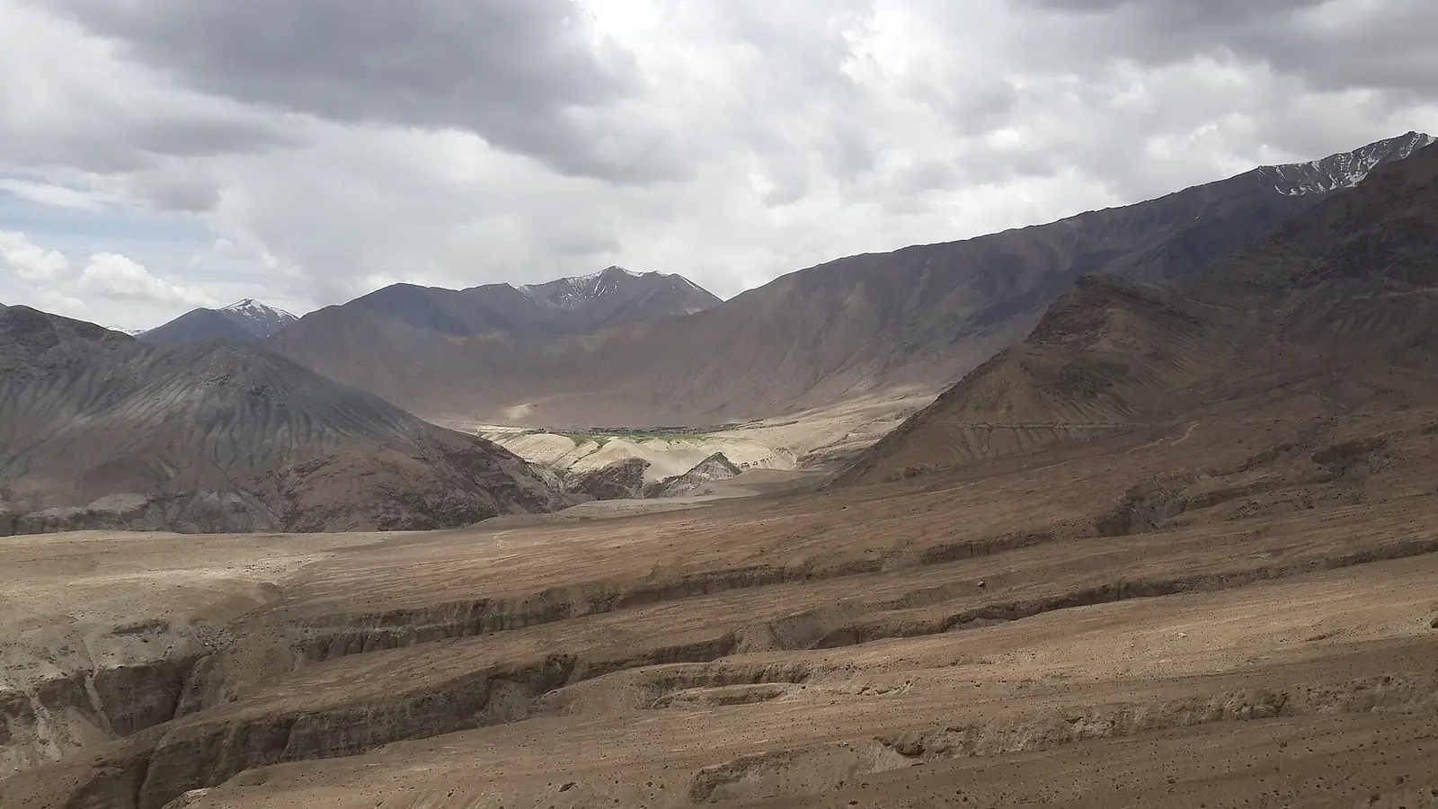 Bare ochre mountains and open sky in the high desert of Ladakh