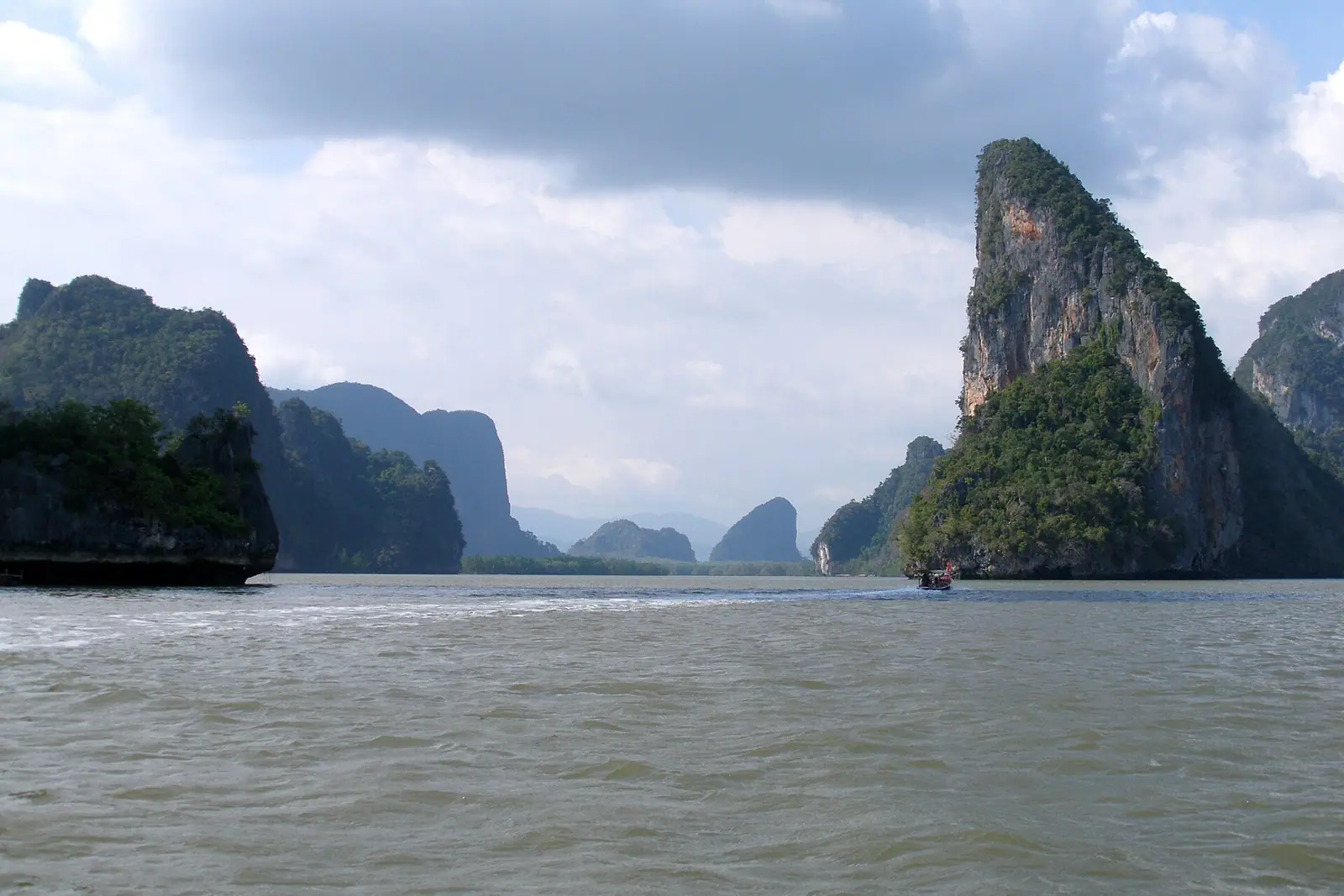 Limestone karst islands standing in calm sea in southern Thailand