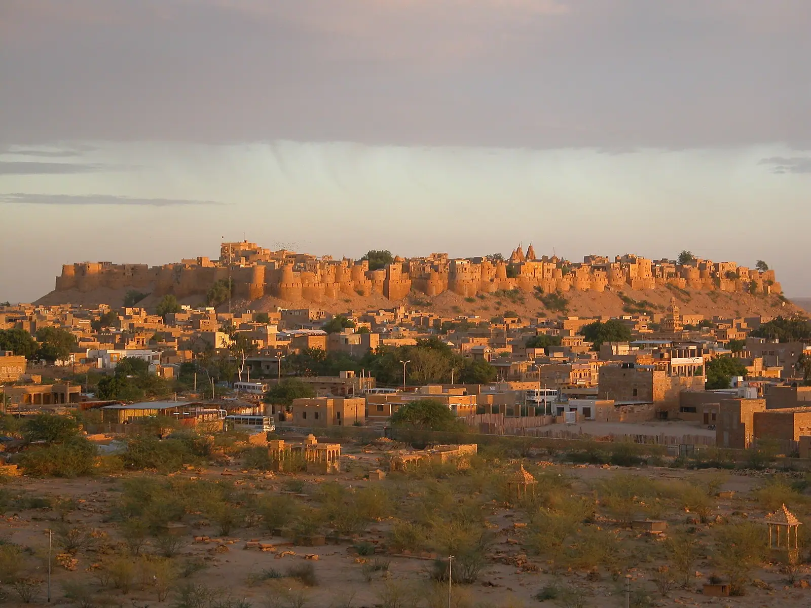 Jaisalmer Fort glowing gold at sunset above the old city, Rajasthan