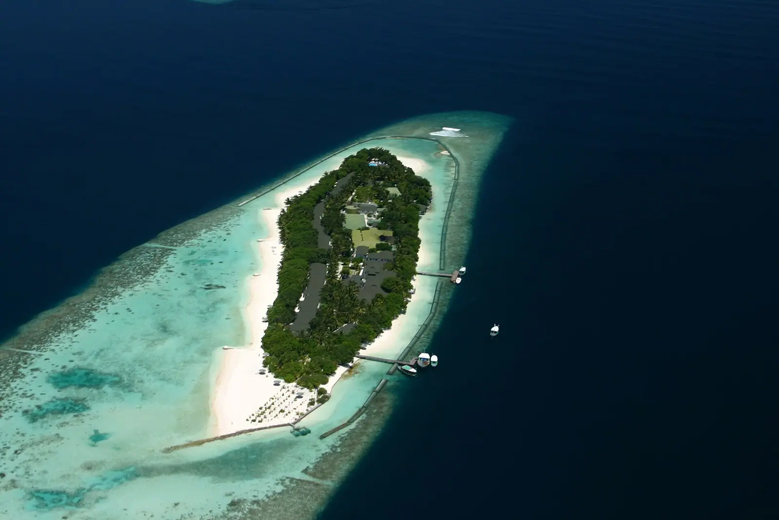 A small resort island ringed by sandbank and reef in the Maldives